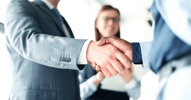 Business professionals shaking hands at a conference