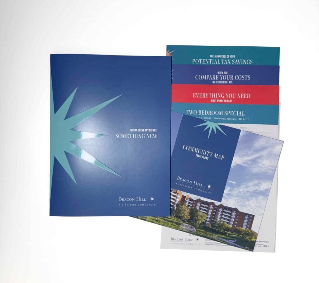 A set of blue and teal brochures with a starburst graphic and a building photo.