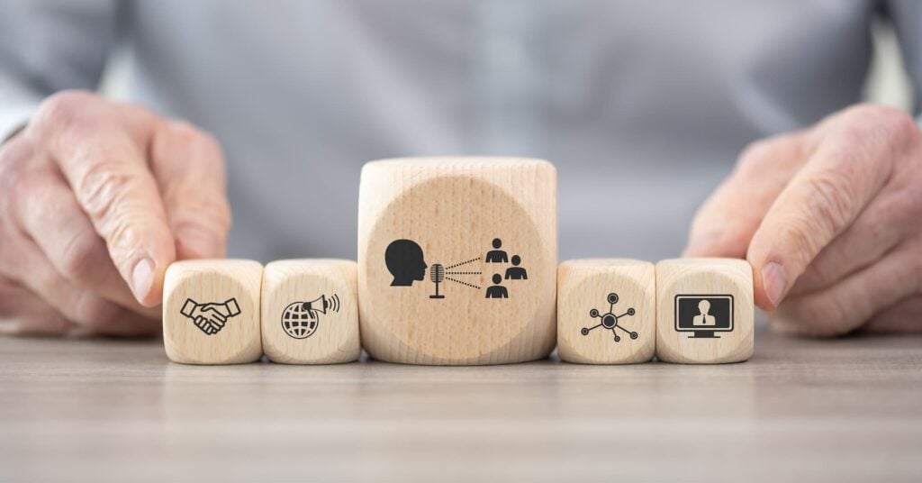 a graphic of building blocks showing expressive icons of the top pillars surrounding public relations